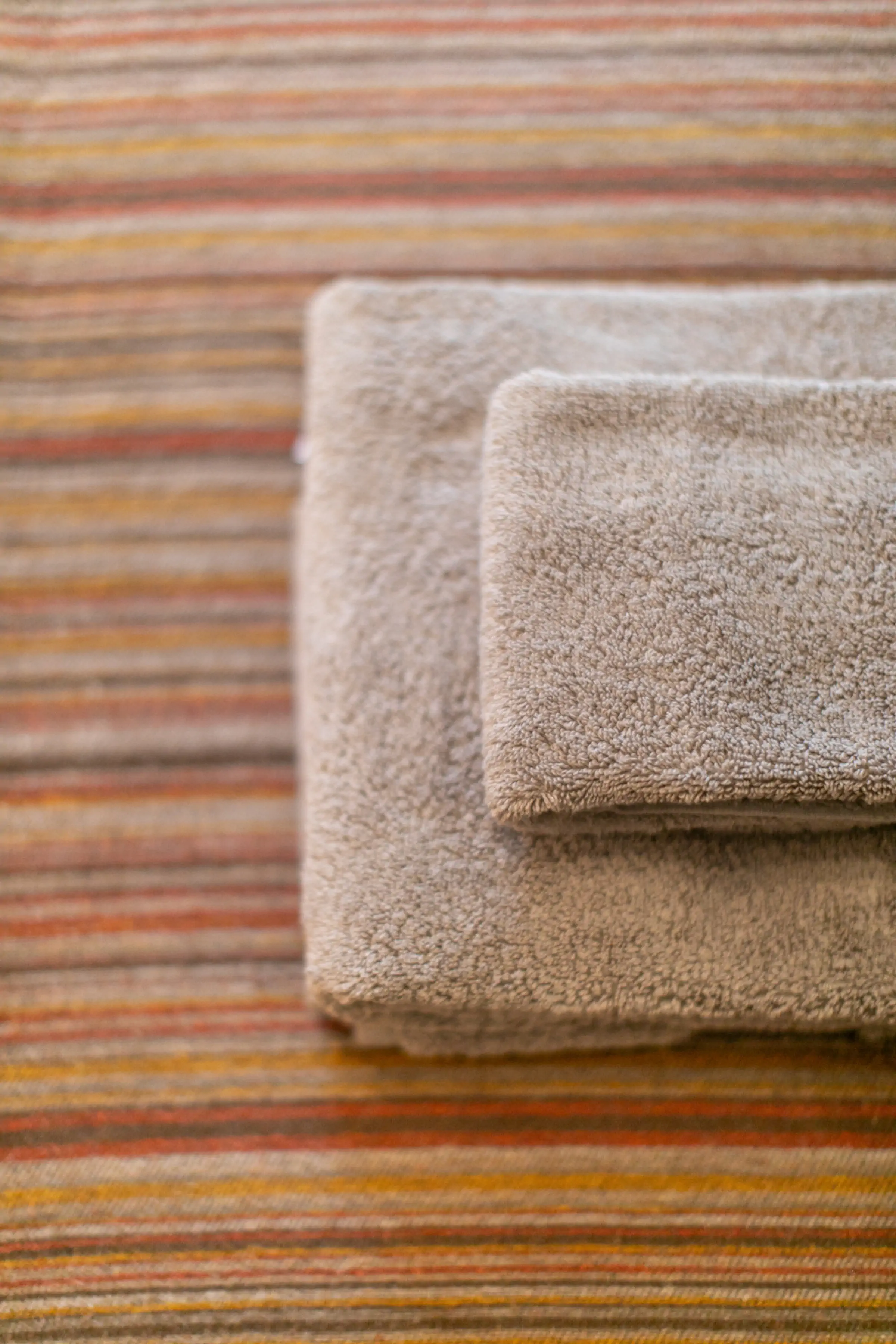Premium striped towels and soft linens detail showcasing quality amenities at Fireside Lodge