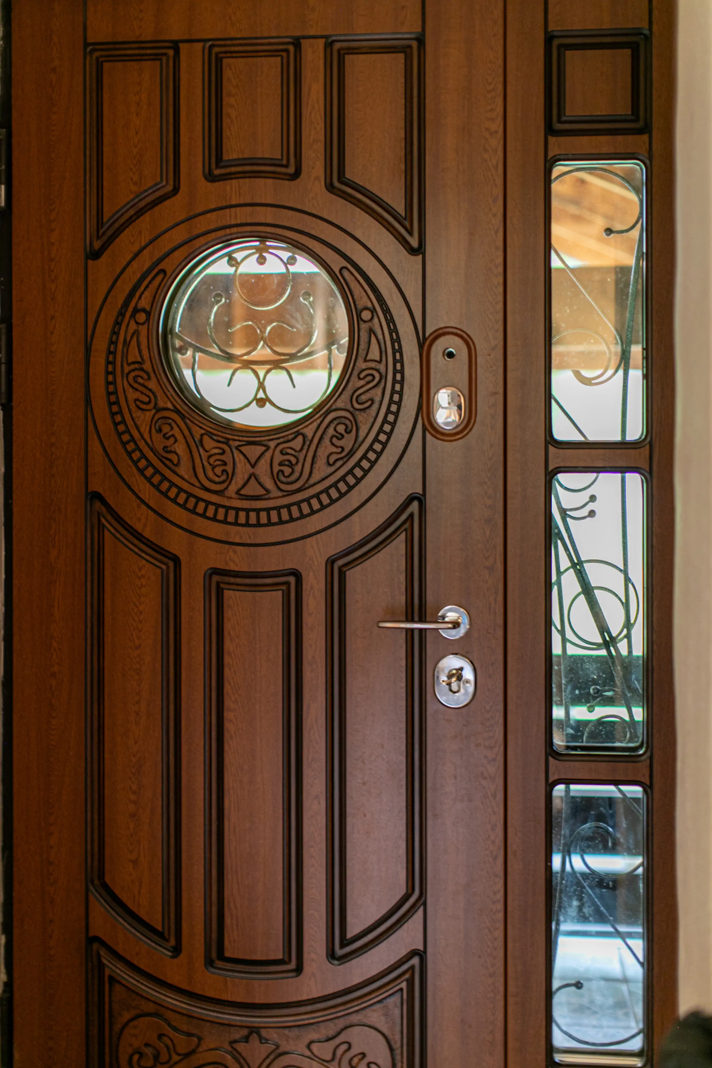 Ornate carved wooden entrance door with decorative glass panels and stained glass accents at Fireside Lodge Montenegro