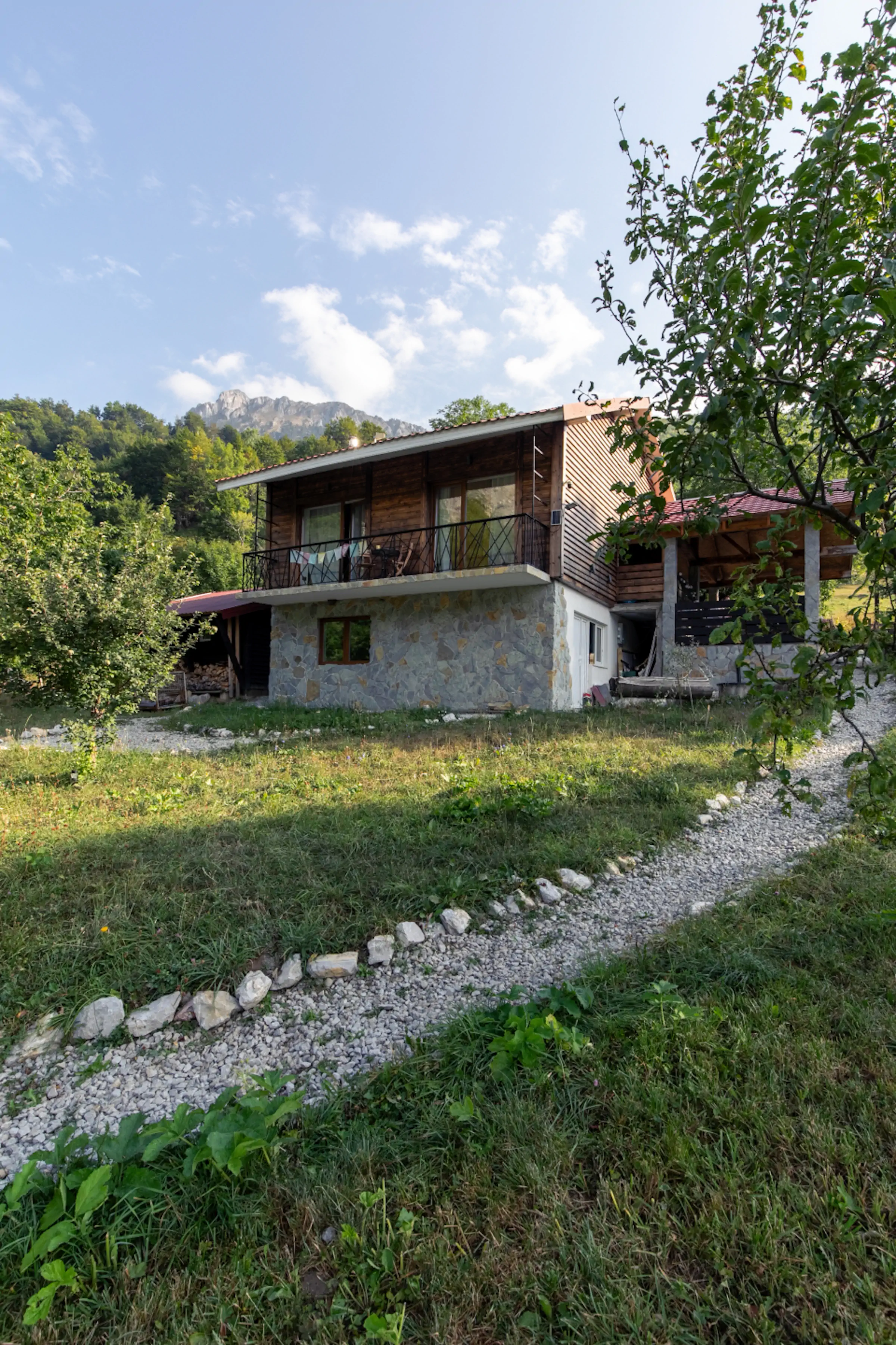 Traditional Montenegro mountain house exterior with stone facade, wooden accents, and gravel driveway in Lipovo Valley